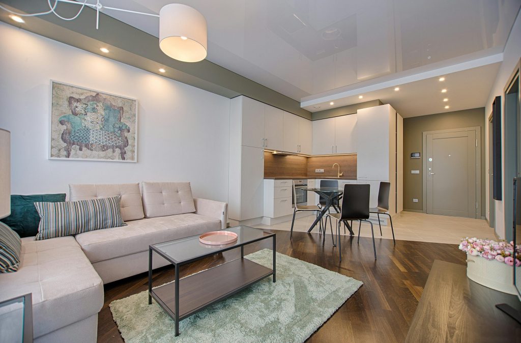 pexels photo 1643383 1643383 Spacious modern living room featuring chic furniture, stylish decor, and a minimalist kitchen.